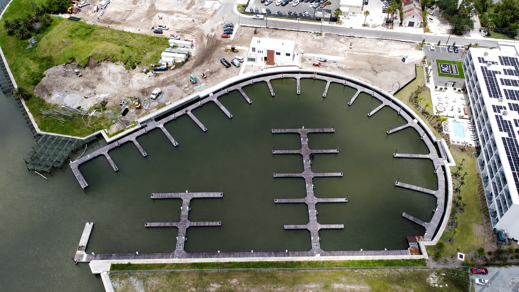 Aerial view of Sebastian Harbor Marina's 64-slip basin and floating docks on the San Sebastian River